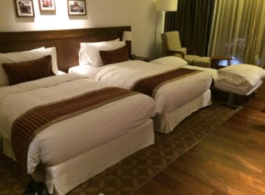 a room with two beds and a chair