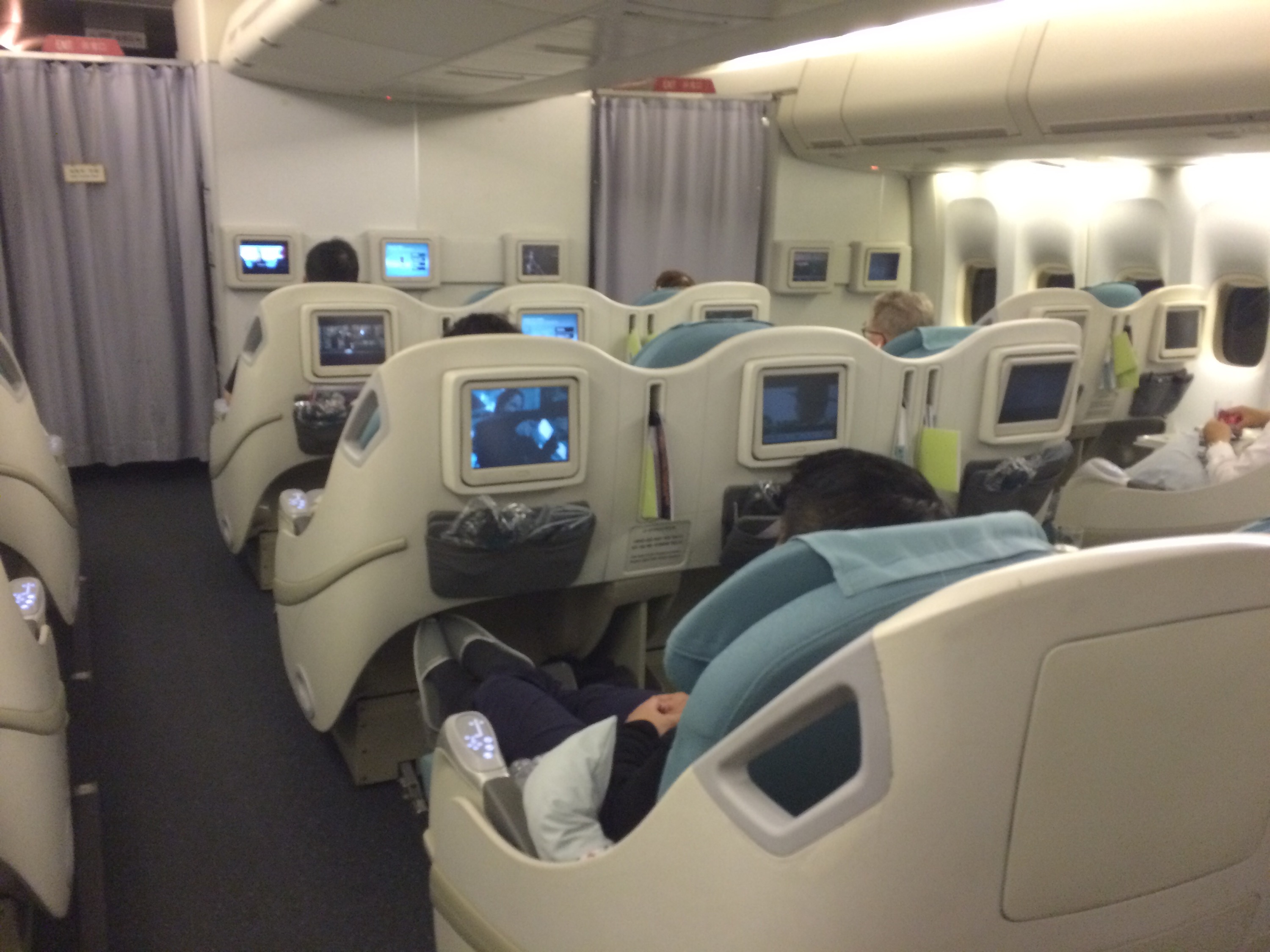 a group of people sitting in chairs on an airplane