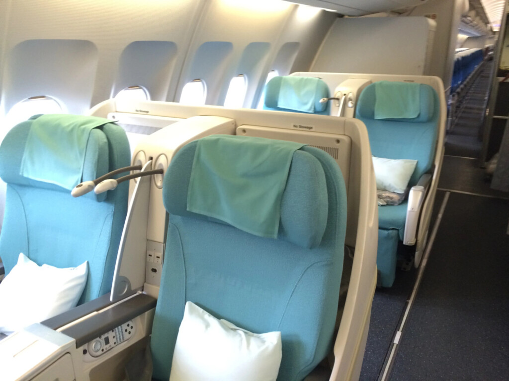 a row of blue seats on an airplane