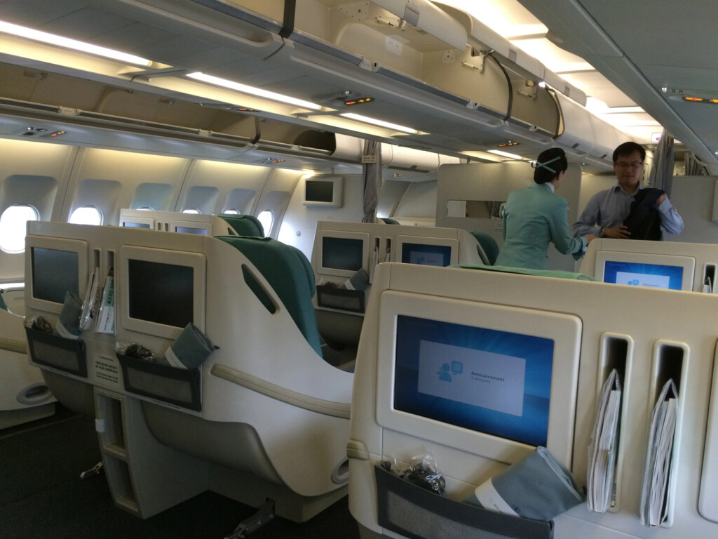 a man and woman standing in an airplane