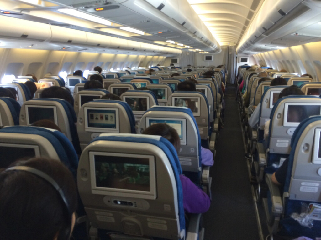 a group of people sitting in an airplane