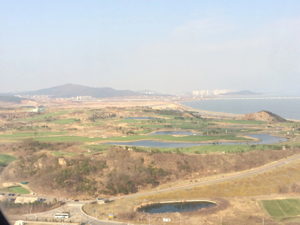 a landscape with a road and water