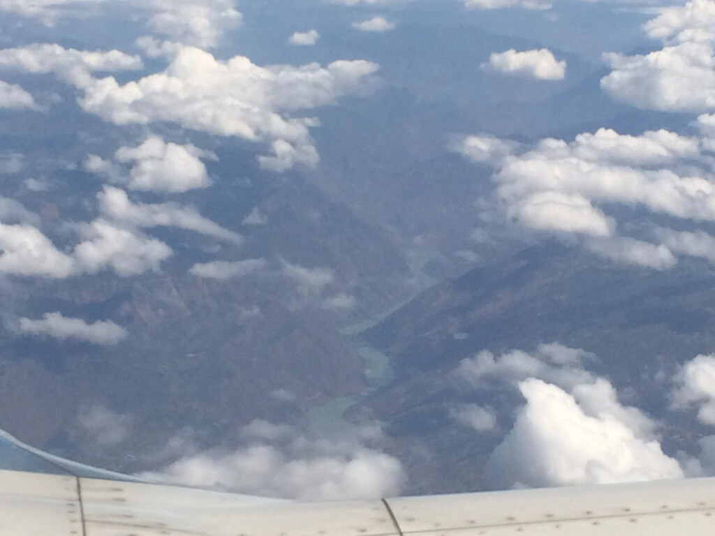 a view of clouds and mountains from an airplane