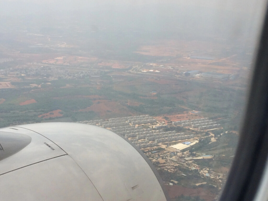 an airplane wing and a city