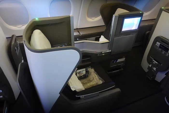 an airplane seat with a screen