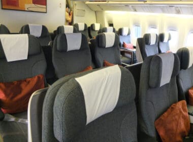 a row of grey and white seats on an airplane
