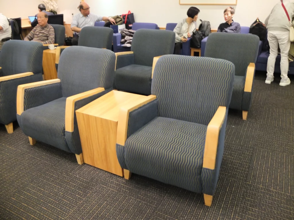 a group of people sitting in a room with chairs