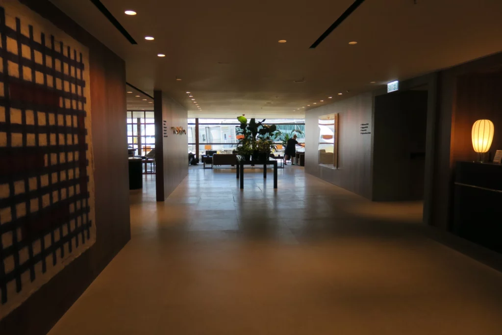 a hallway with a table and a plant