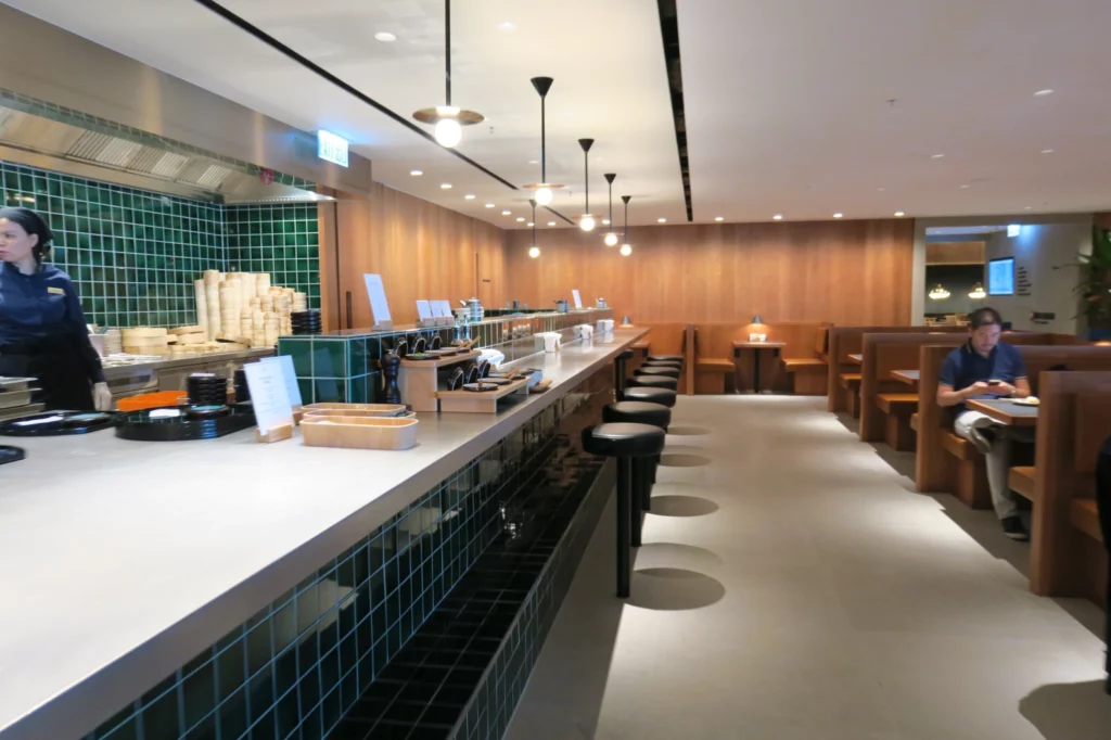 a restaurant with a long counter and chairs