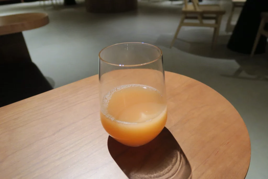 a glass of orange liquid on a table