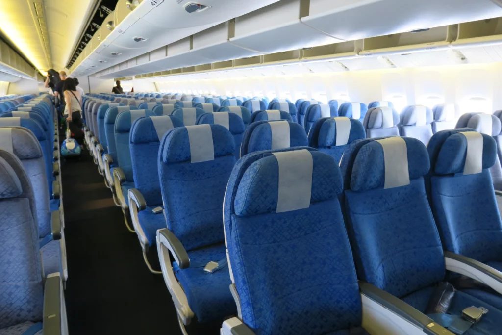 a row of blue seats in an airplane