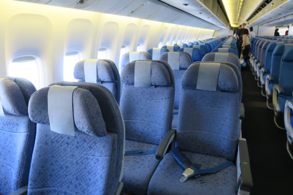 a row of blue seats on an airplane