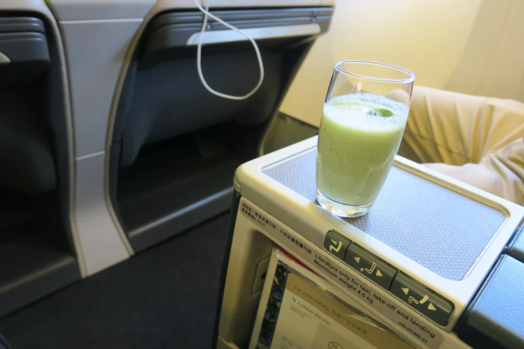 a glass of green liquid on a table