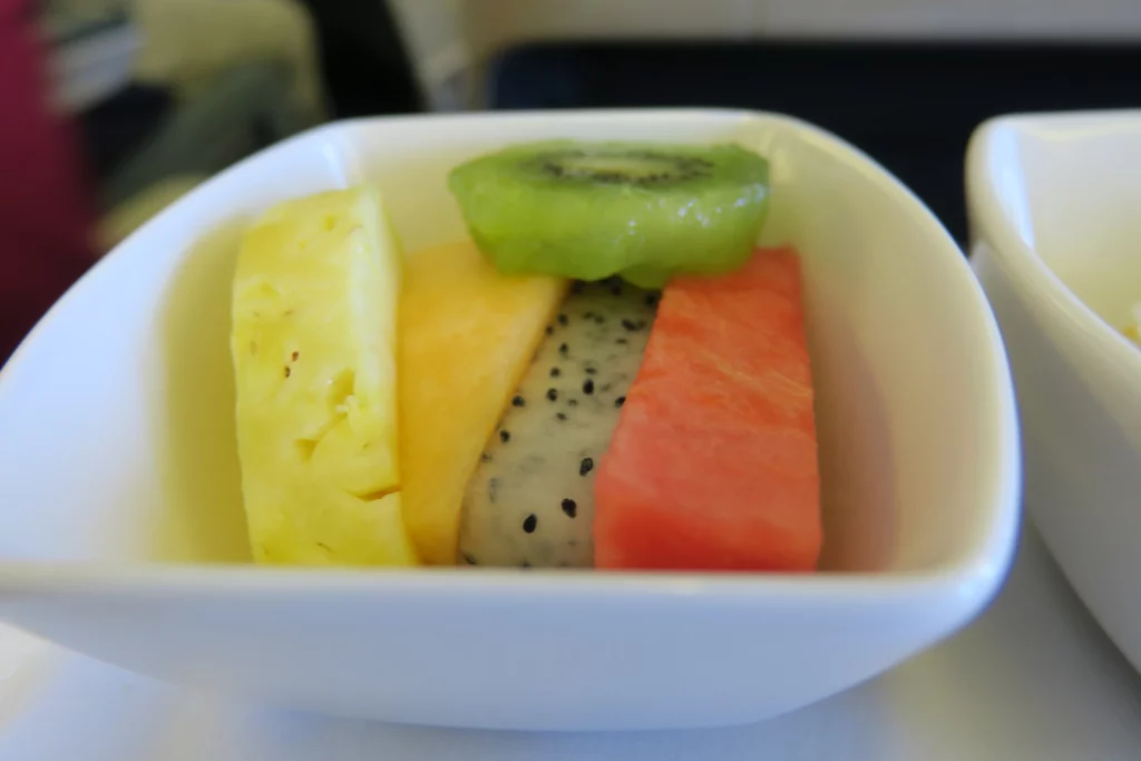 a bowl of fruit in a white bowl