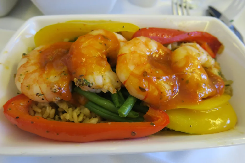 a plate of food with shrimp and vegetables