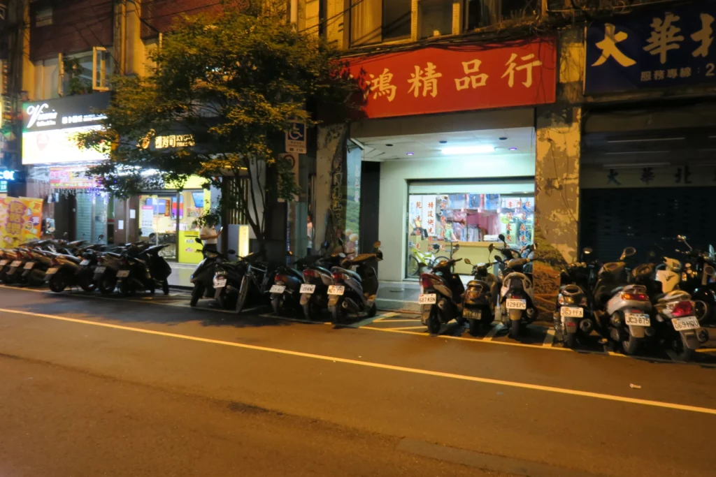 a row of motorcycles parked in front of a store