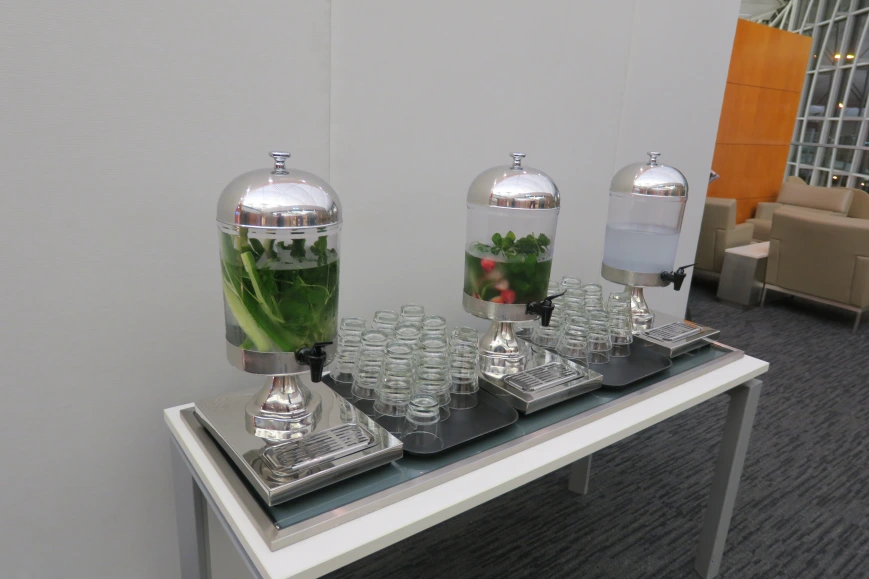 a group of glass containers with liquid and water in them