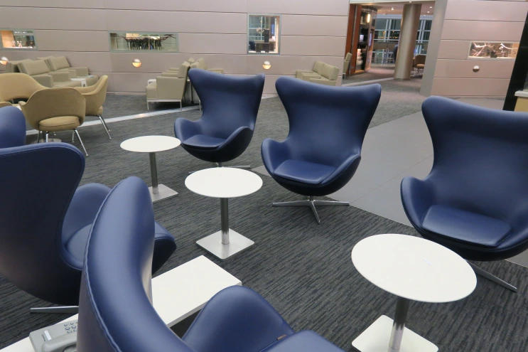 a group of chairs and tables in a room
