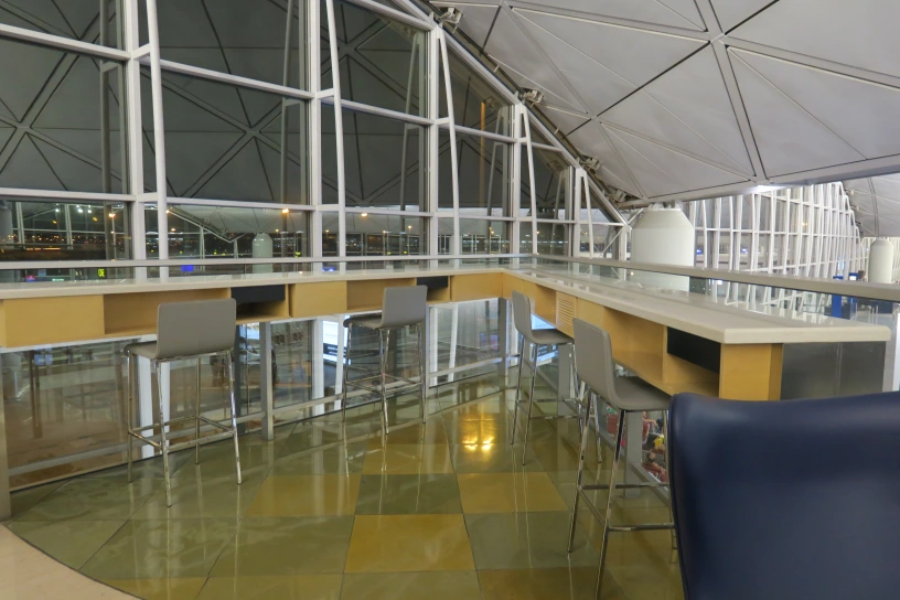 a bar with chairs and a glass roof