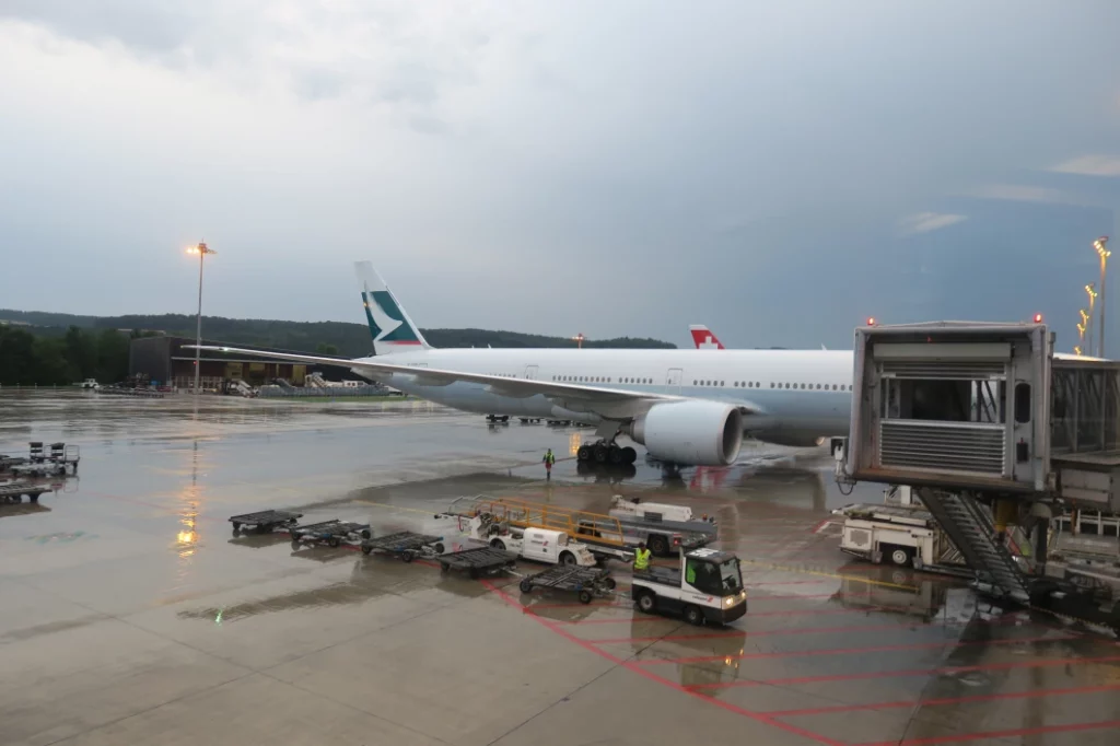 a large white airplane on a wet tarmac