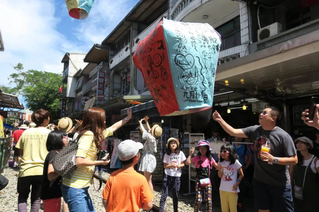 a group of people outside with a large lantern