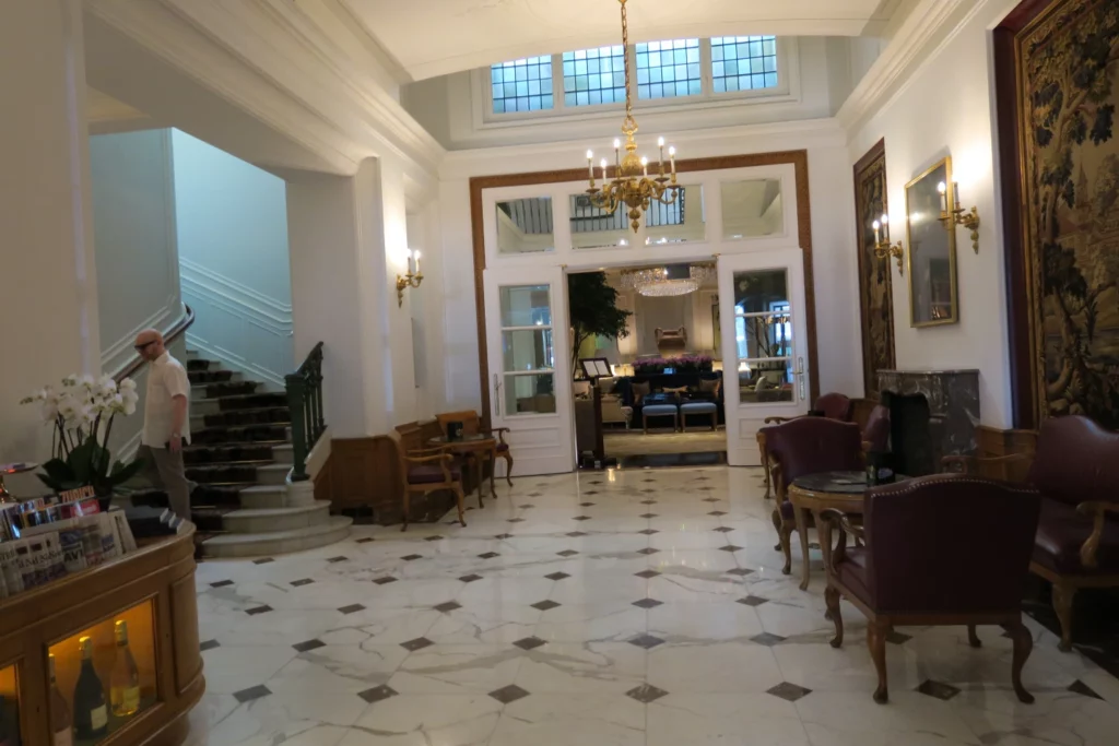 a room with a marble floor and a chandelier