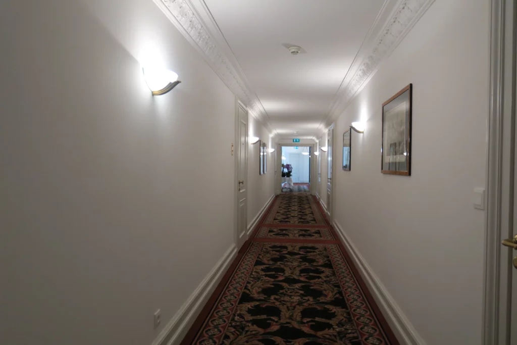 a hallway with a carpet and lights