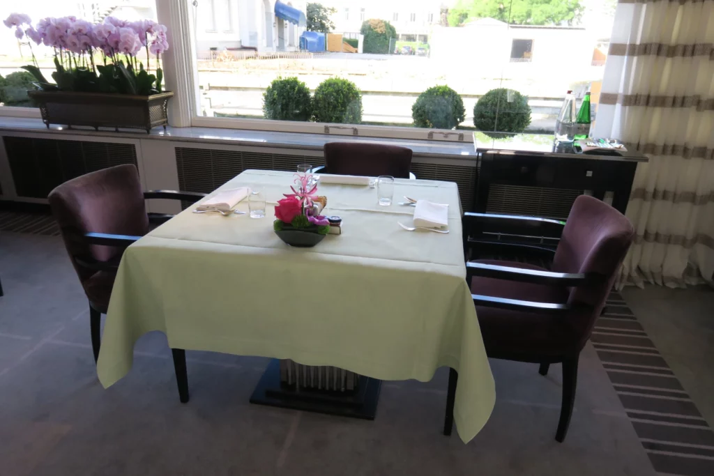 a table with a white tablecloth and chairs