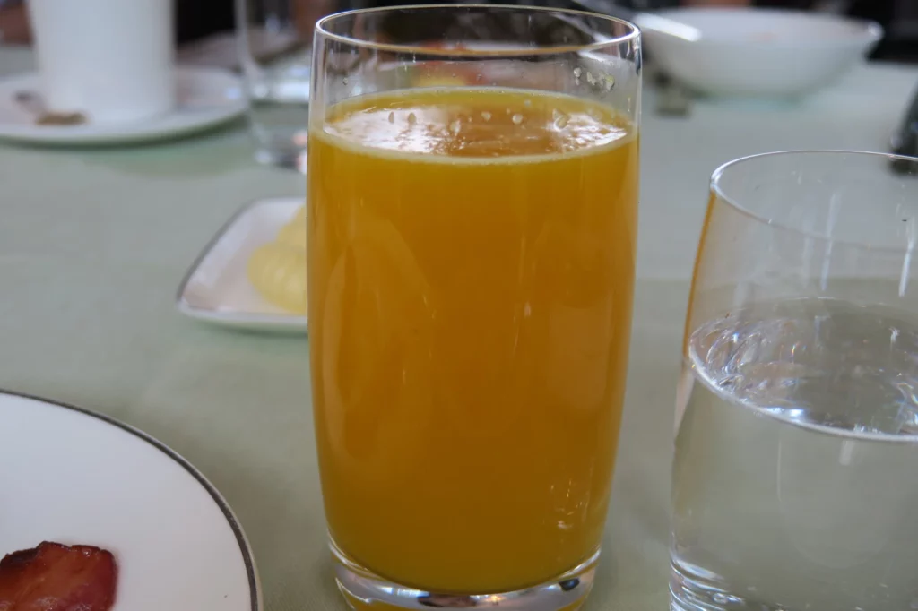 a glass of orange juice on a table