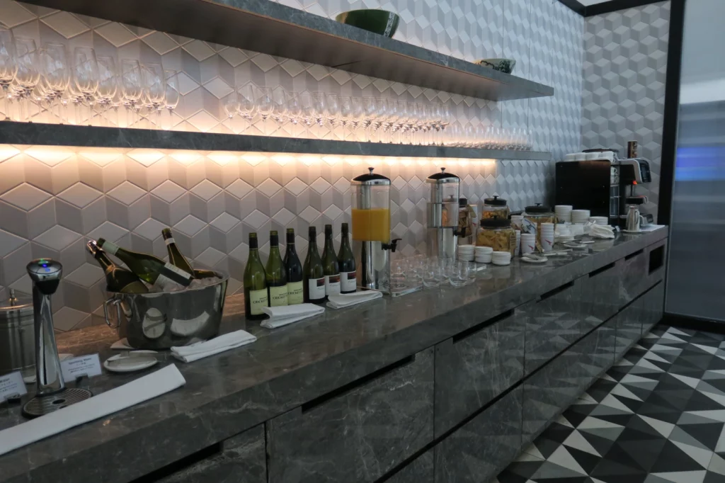 a counter with wine glasses and bottles