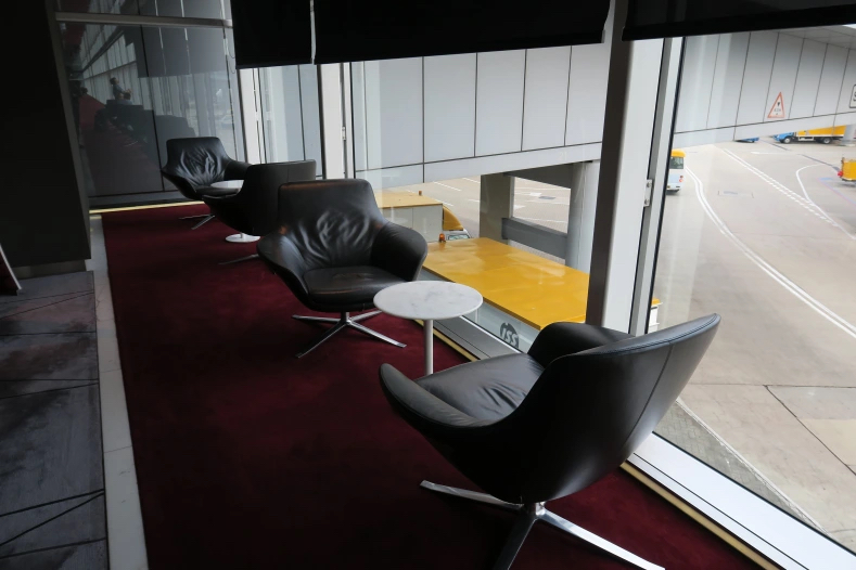 a row of black chairs and a table