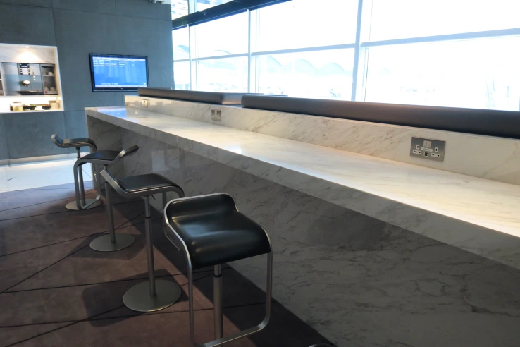 a bar counter with stools and a tv