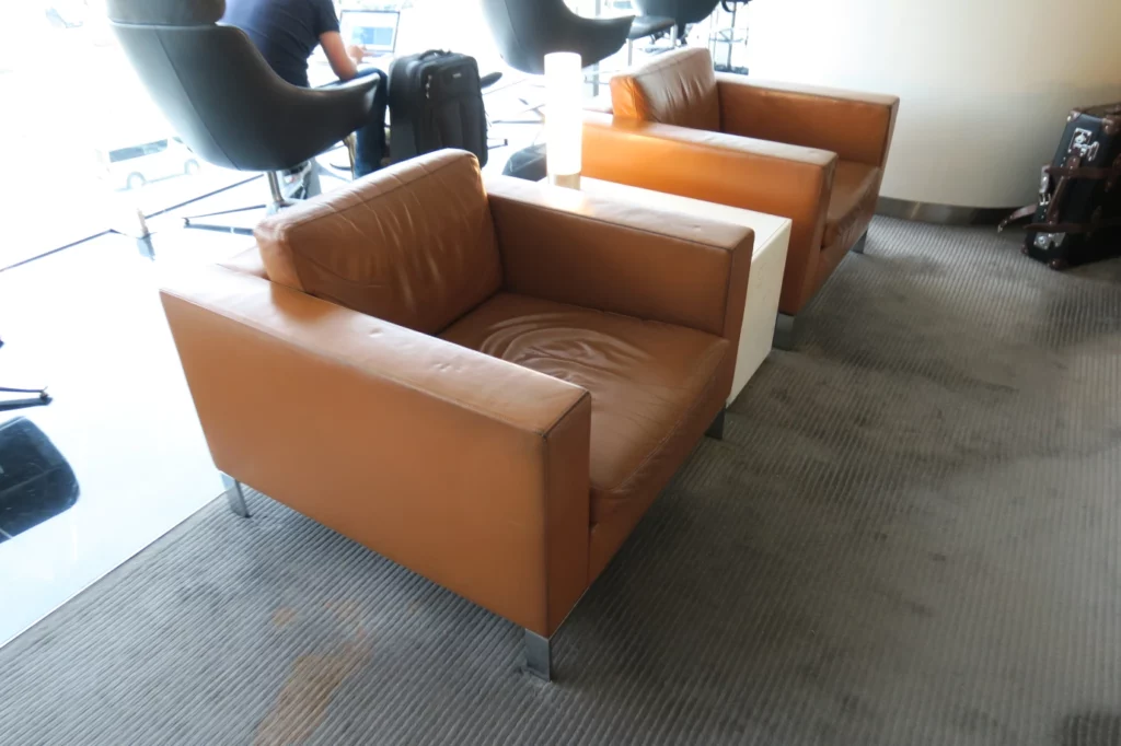 a group of brown leather chairs