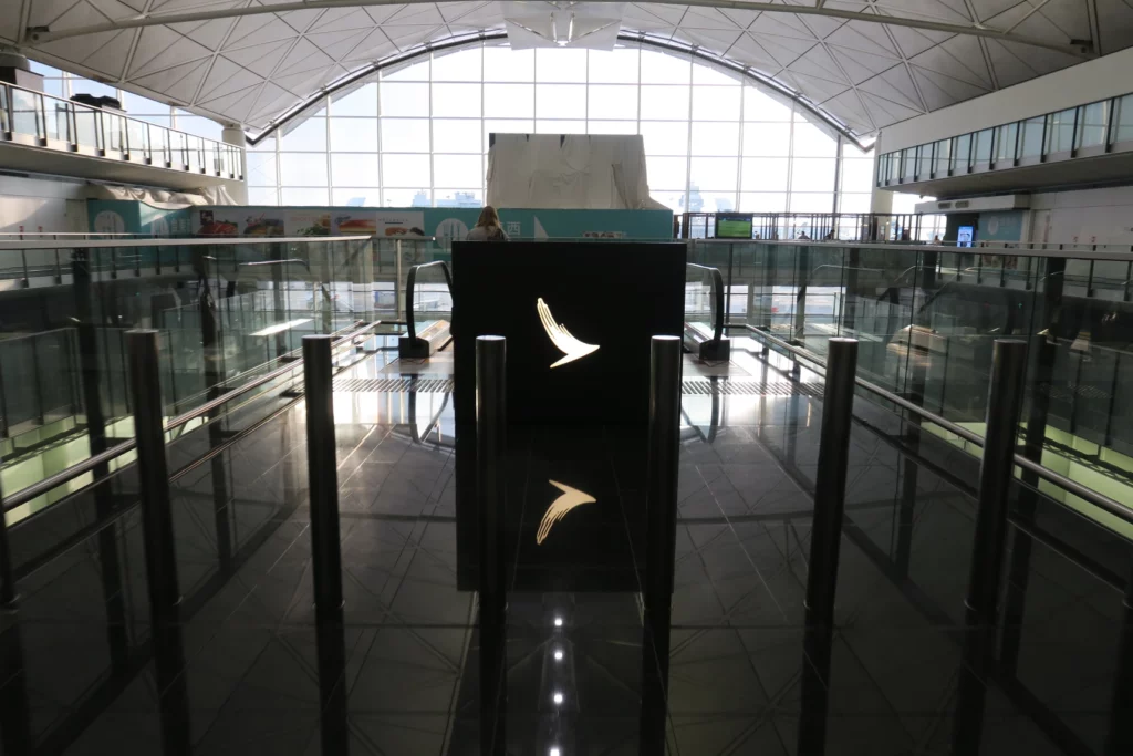 a black box with a logo on it in a glass building