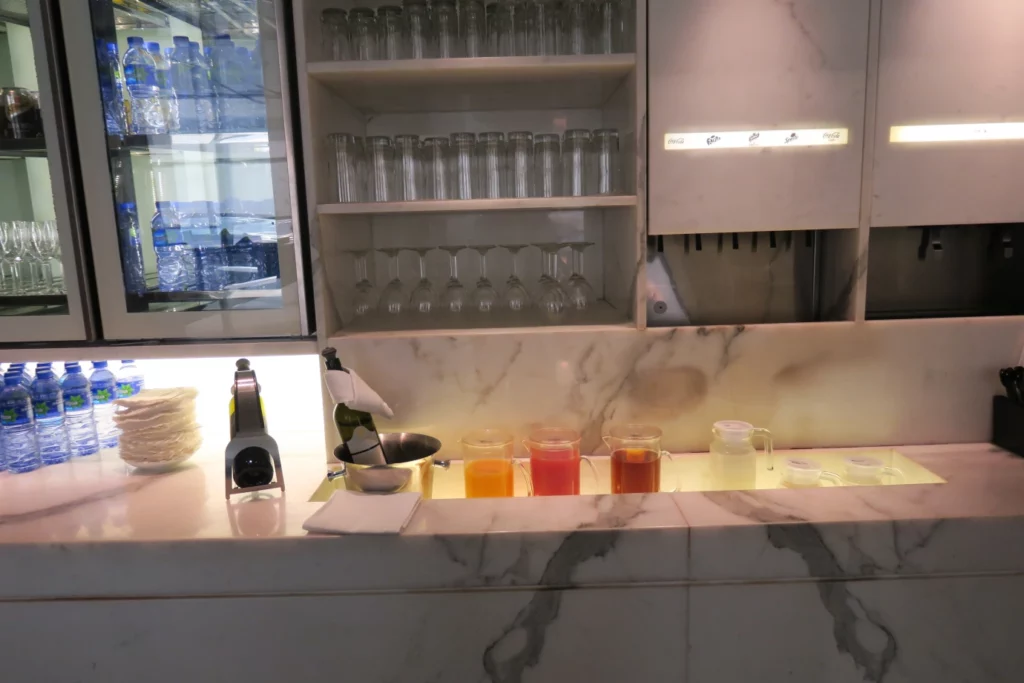 a counter with glasses and a shelf with glasses on it