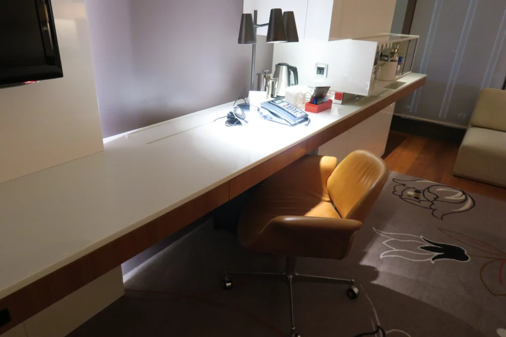 a desk with a chair and a telephone on it