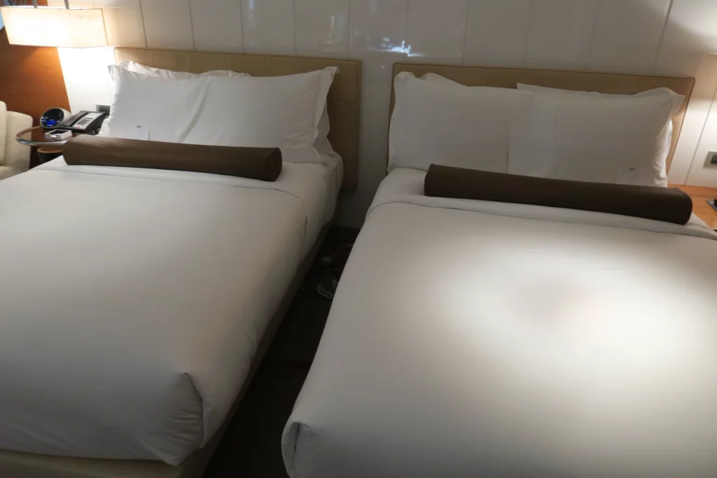 two beds with white sheets