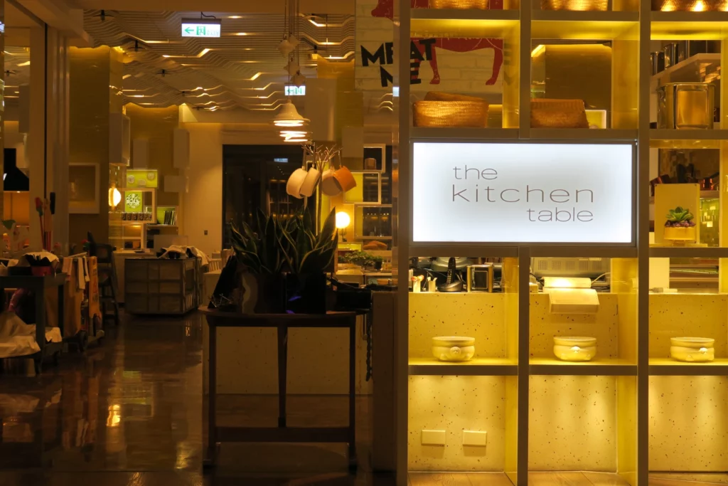 a room with a kitchen table and shelves