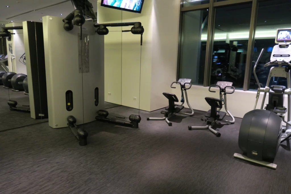 a room with exercise bikes and a tv