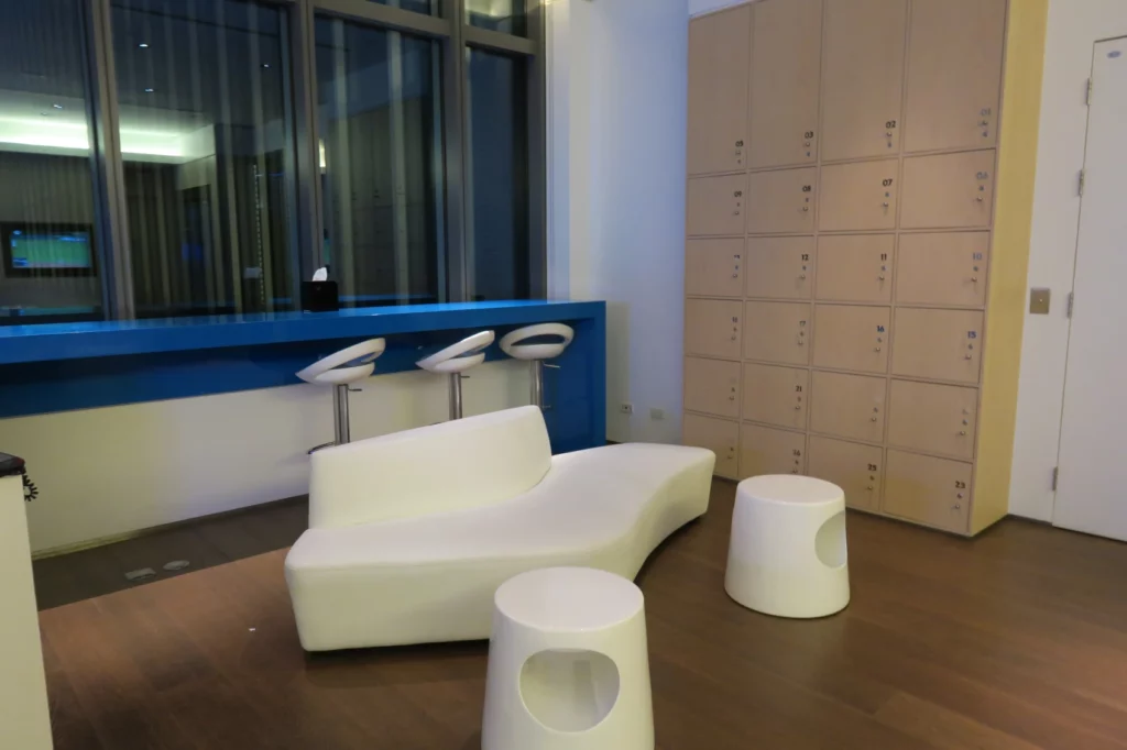 a white couch and stools in a room