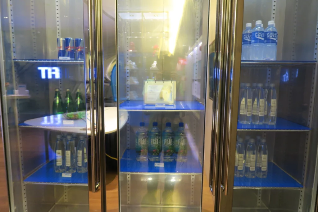 a refrigerator with bottles of water