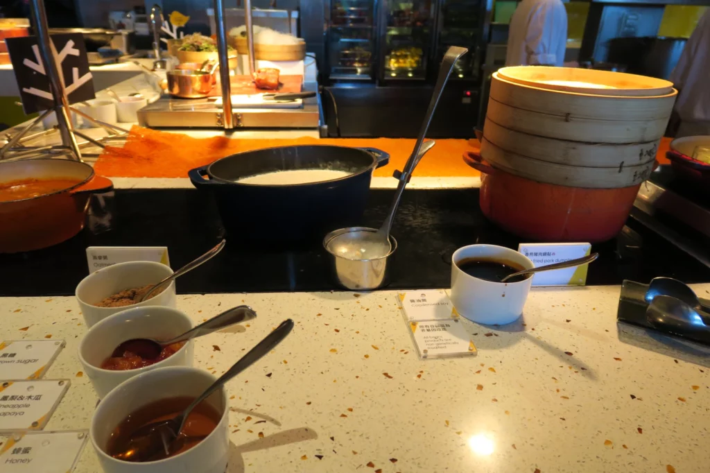 a counter with bowls of food and utensils