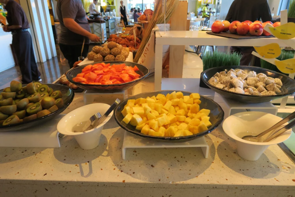 a table with bowls of fruit and bowls of food