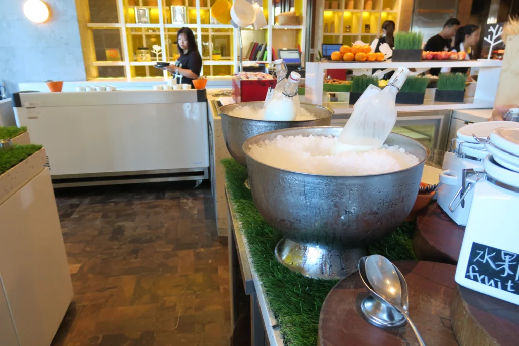 a group of bowls with ice and bottles in a restaurant