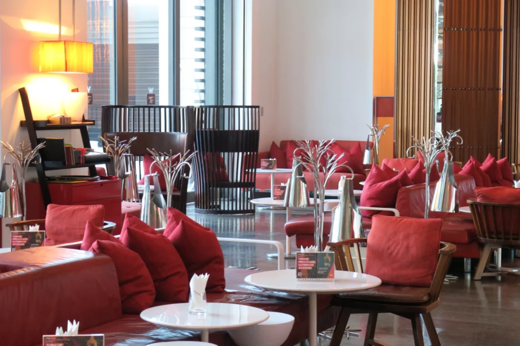 a room with red couches and tables