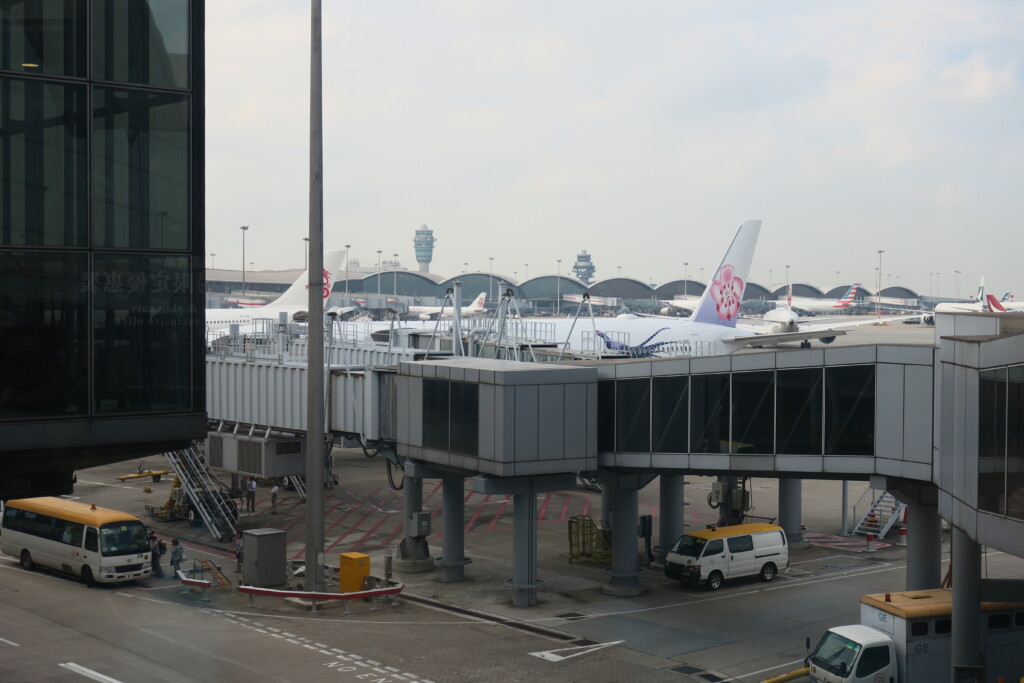 an airport with a plane and cars