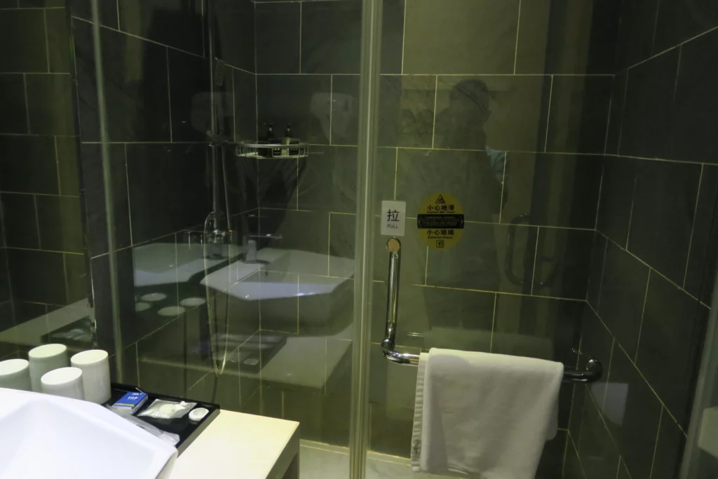 a bathroom with a glass shower door