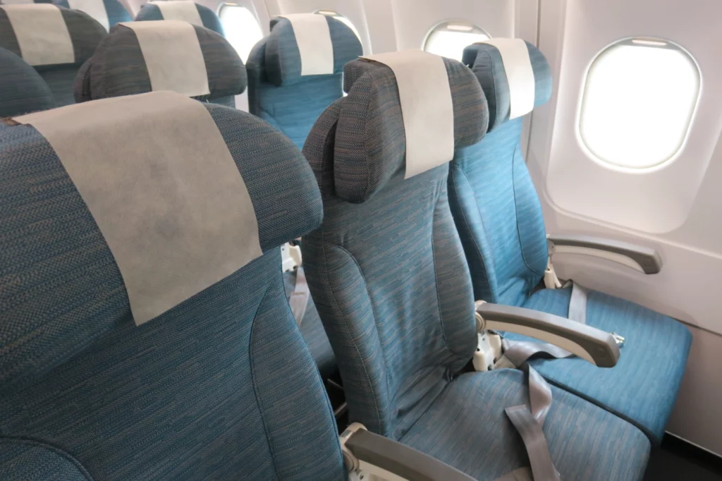 a row of blue seats on an airplane