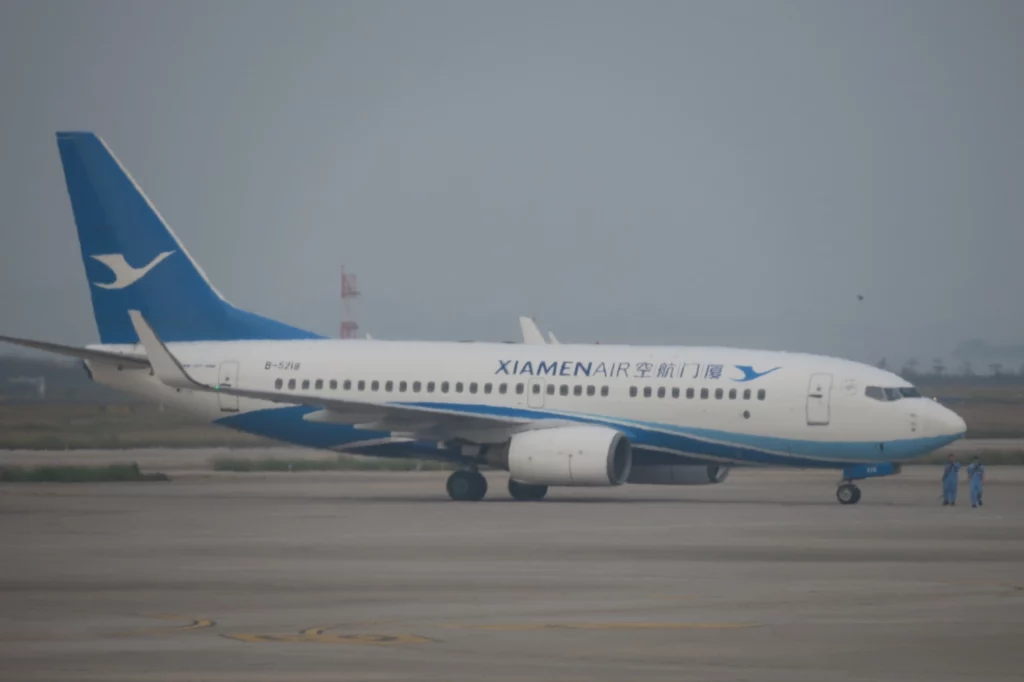 a white and blue airplane on a runway