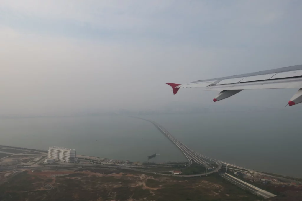 an airplane wing and a body of water